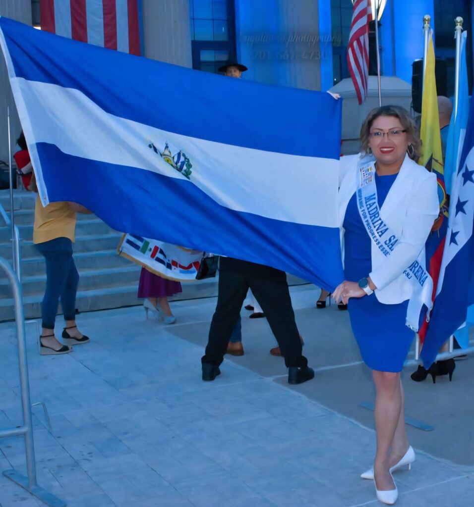 Jenny Lozano Rivera holding the Salvadoran flag at a cultural celebration